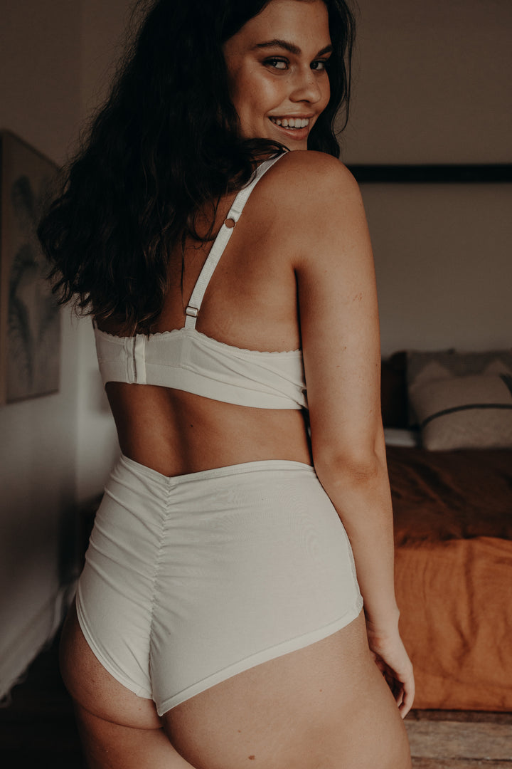 model showing back view of white bralette