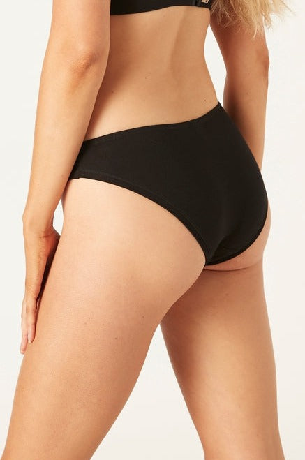 A rear view of a person wearing a black organic cotton bikini brief with a classic design.
