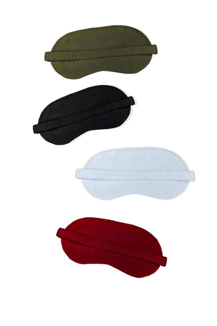 Four bamboo sleep masks shown in olive, black, light blue, and red, arranged in a flat grid.