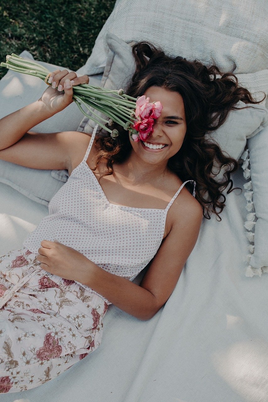 model wearing organic cotton pyjamas holding flowers