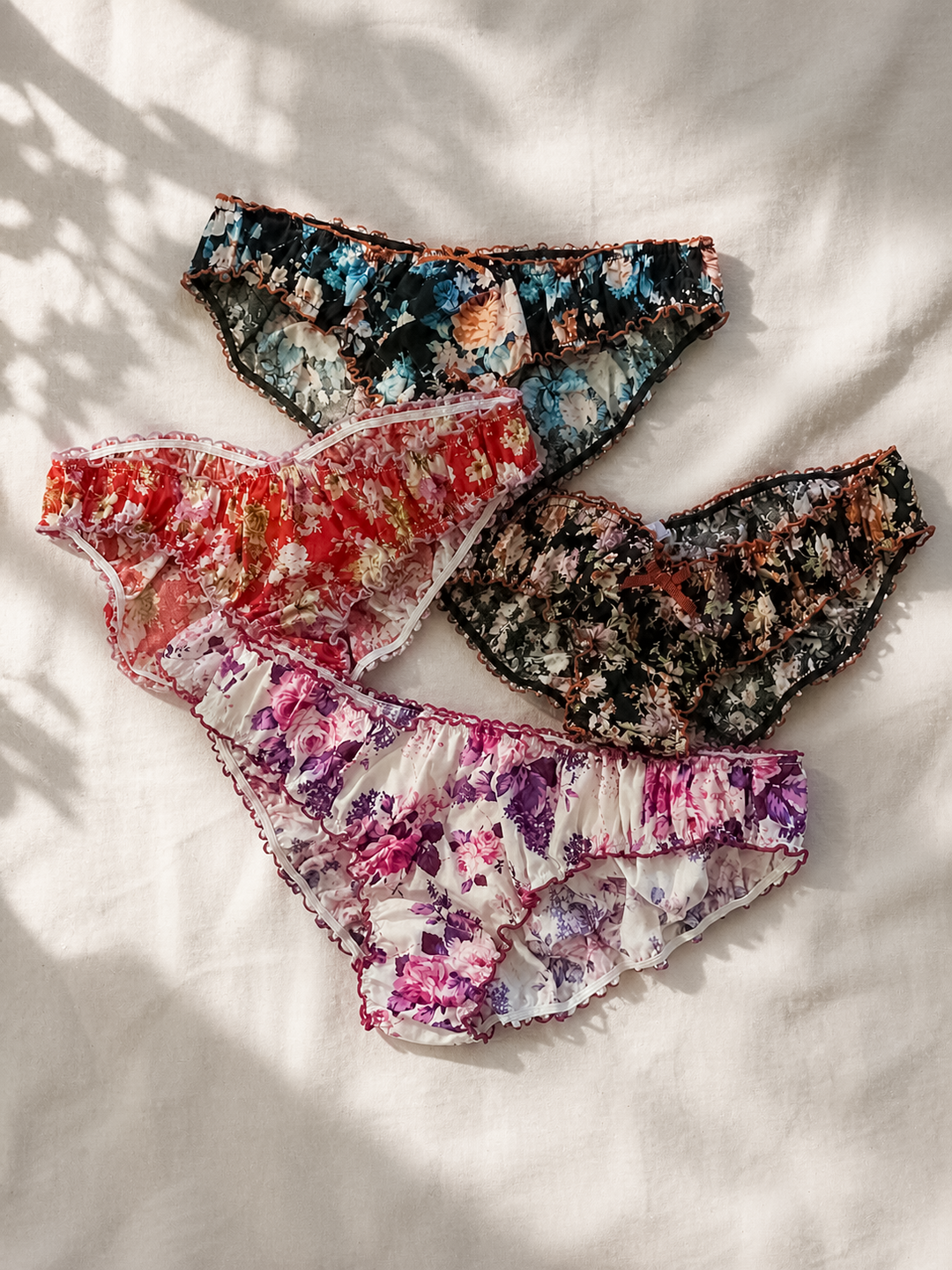 Three pairs of floral-patterned underwear on a light background