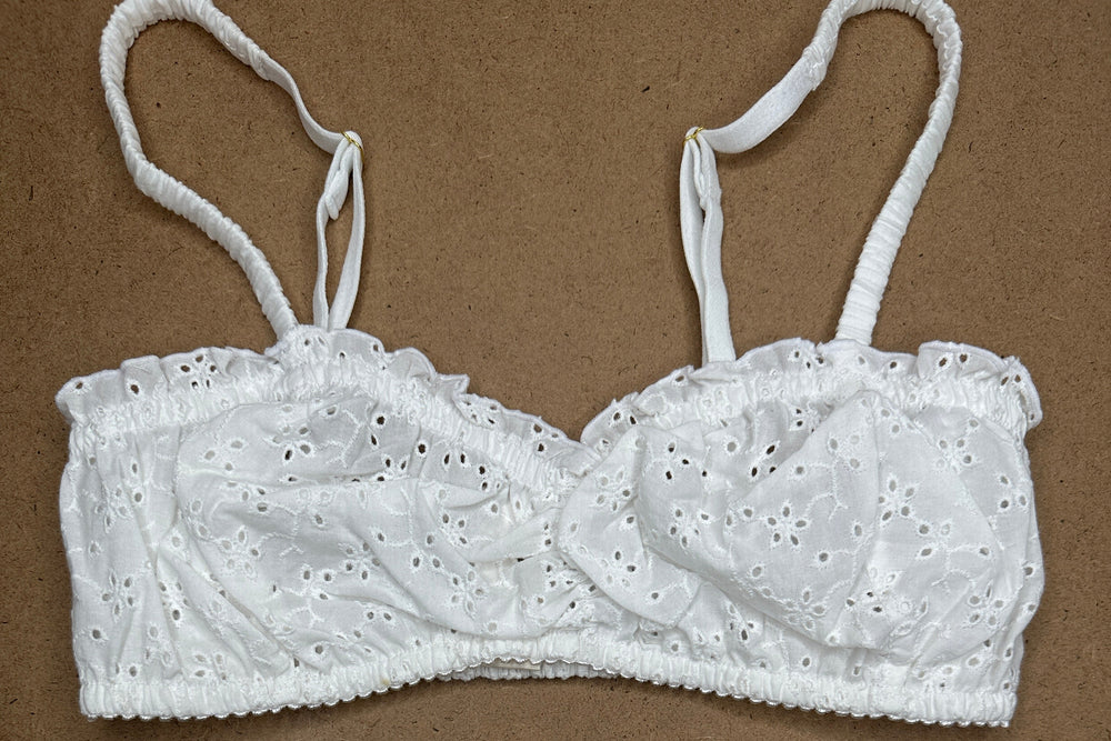 White lace lingerie set on a brown background