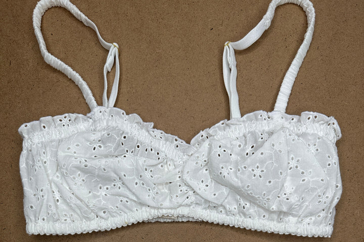 White lace lingerie set on a brown background