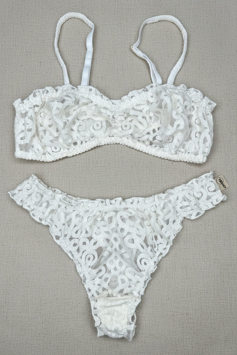 White lace lingerie set on a brown surface