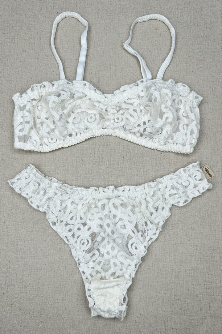 White lace lingerie set on a brown surface