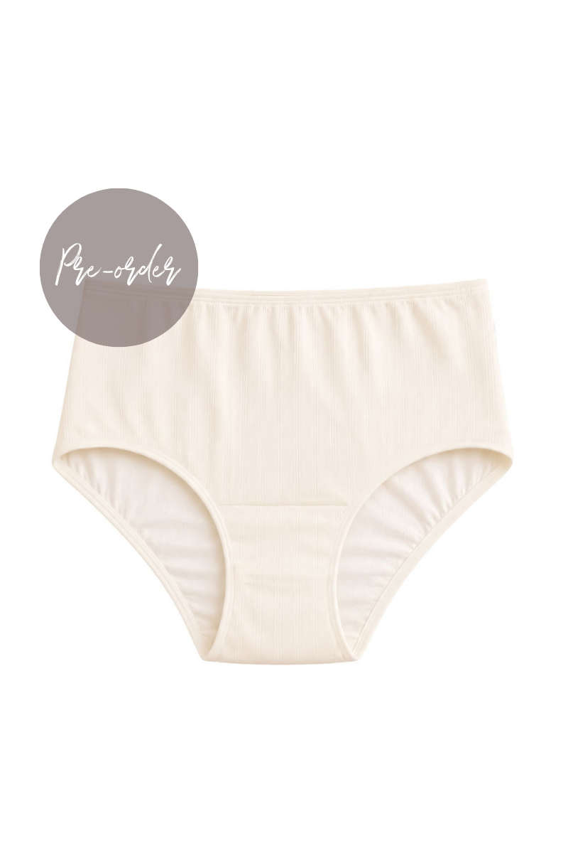 A pair of women's mid rise briefs in a warm cream or off-white color, shown flat against a white background with a gray circular label reading 'Pre-order' in the upper left.