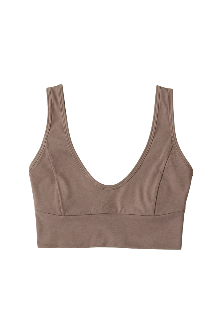 A SOFT BROWN, crop bra made from organic cotton, with a v-neckline and wide straps.