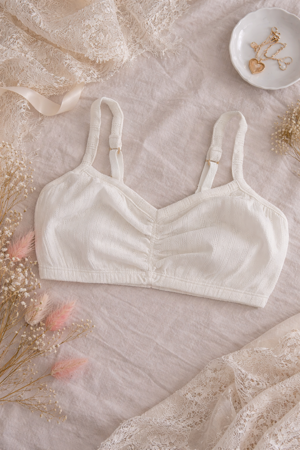 White organic cotton bralette on a textured surface with decorative elements