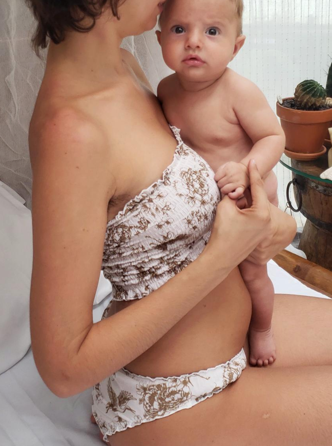 mother holding baby in organic cotton underwear