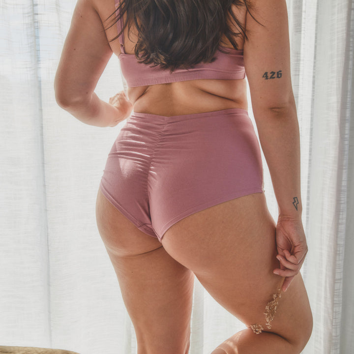 model showing back view of high waisted knickers in dusty rose