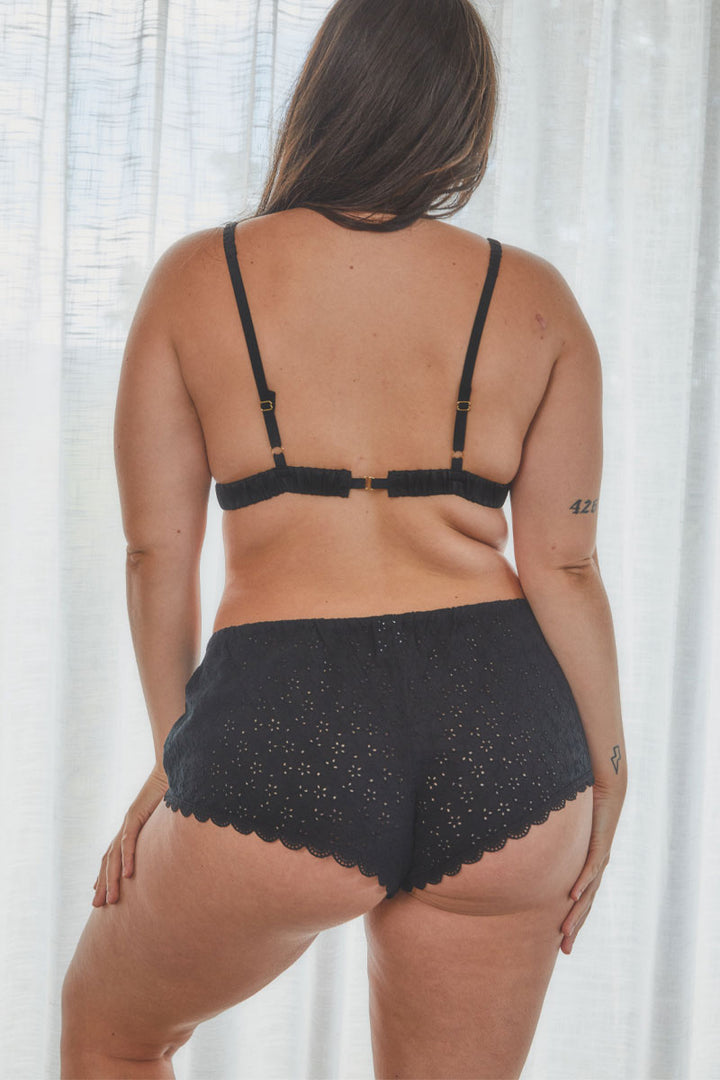 back view of model showing broderie anglaise bralette in black