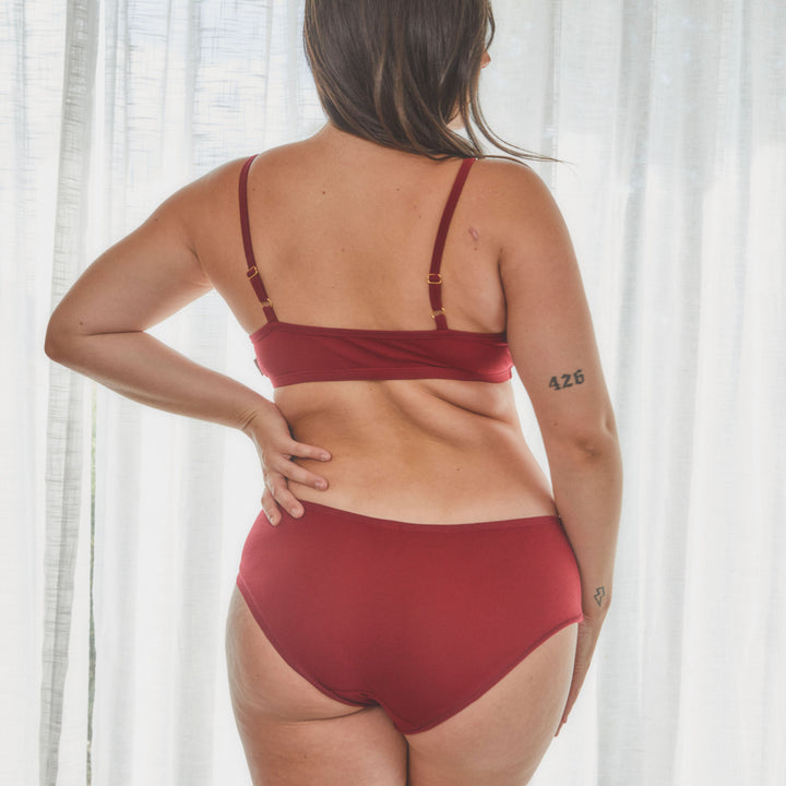 model showing back view of organic cotton bralette in red