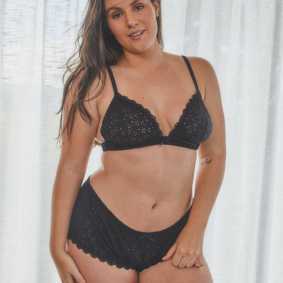 model showing broderie anglaise lingerie set in black